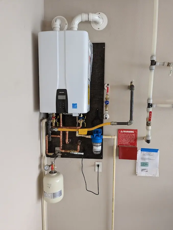 Professional plumber installing copper piping in a Stockton home